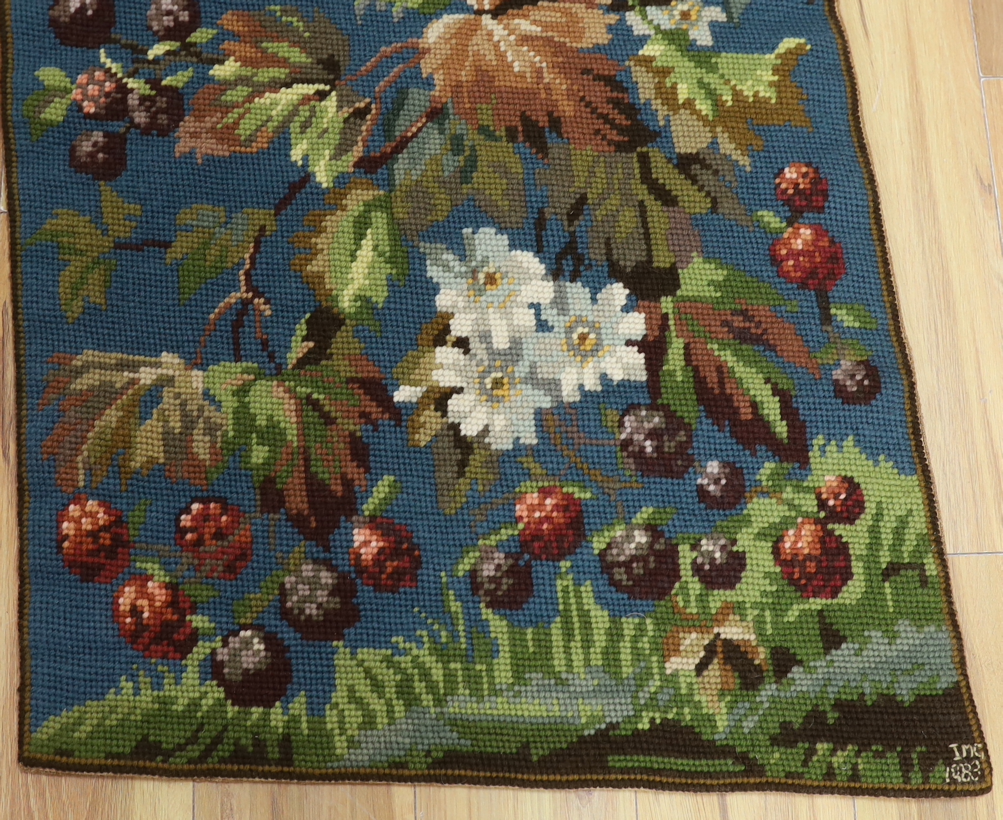 A 20th century woolworked hanging, leaves and flowers, monogrammed and dated